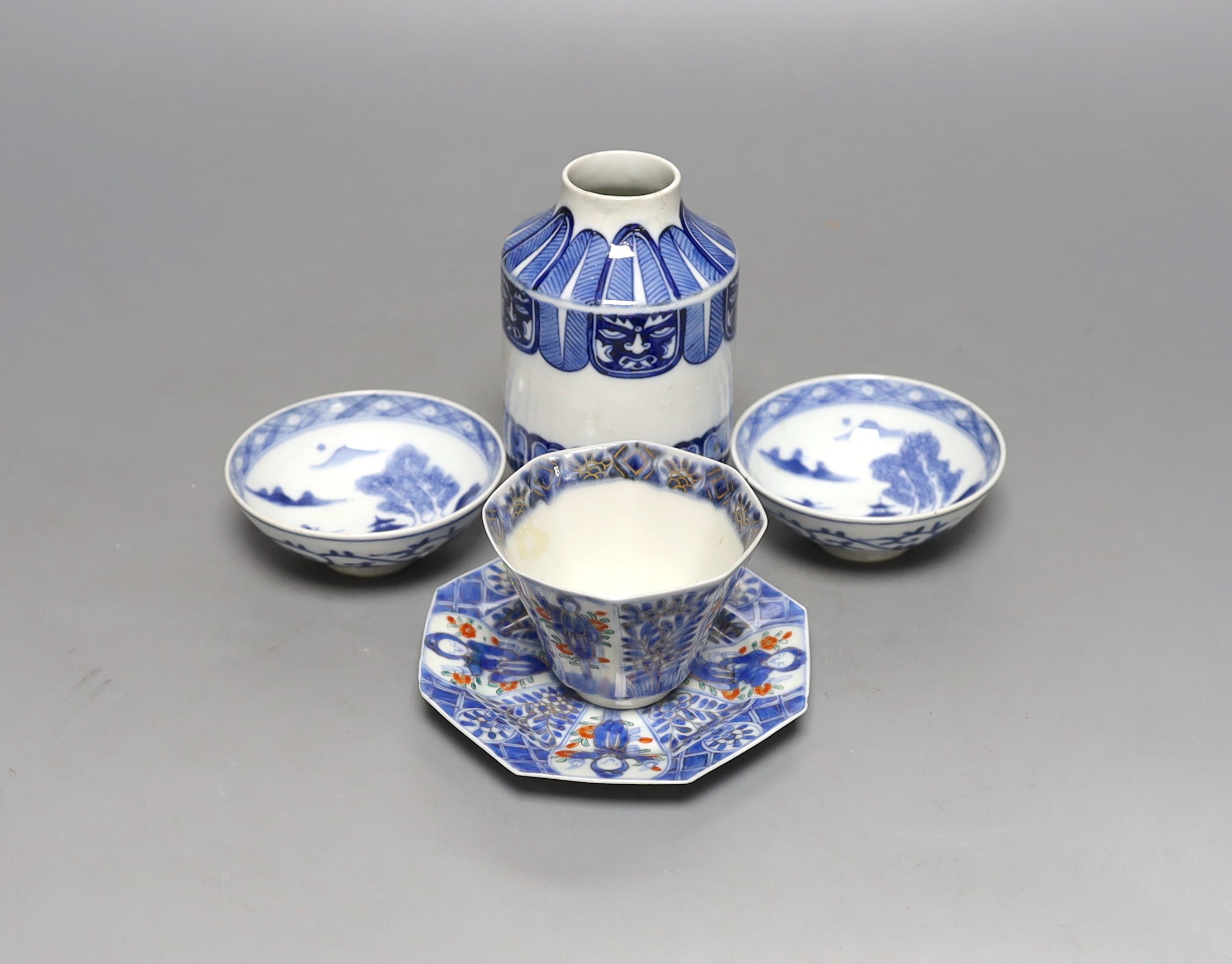 A Japanese blue and white vase, two similar dishes and a tea bowl and saucer